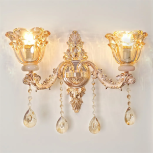 Antique gold two-arm floral wall sconce with hanging crystal accents, lit