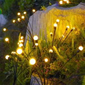 Solar firefly lights with flexible stems in garden bed